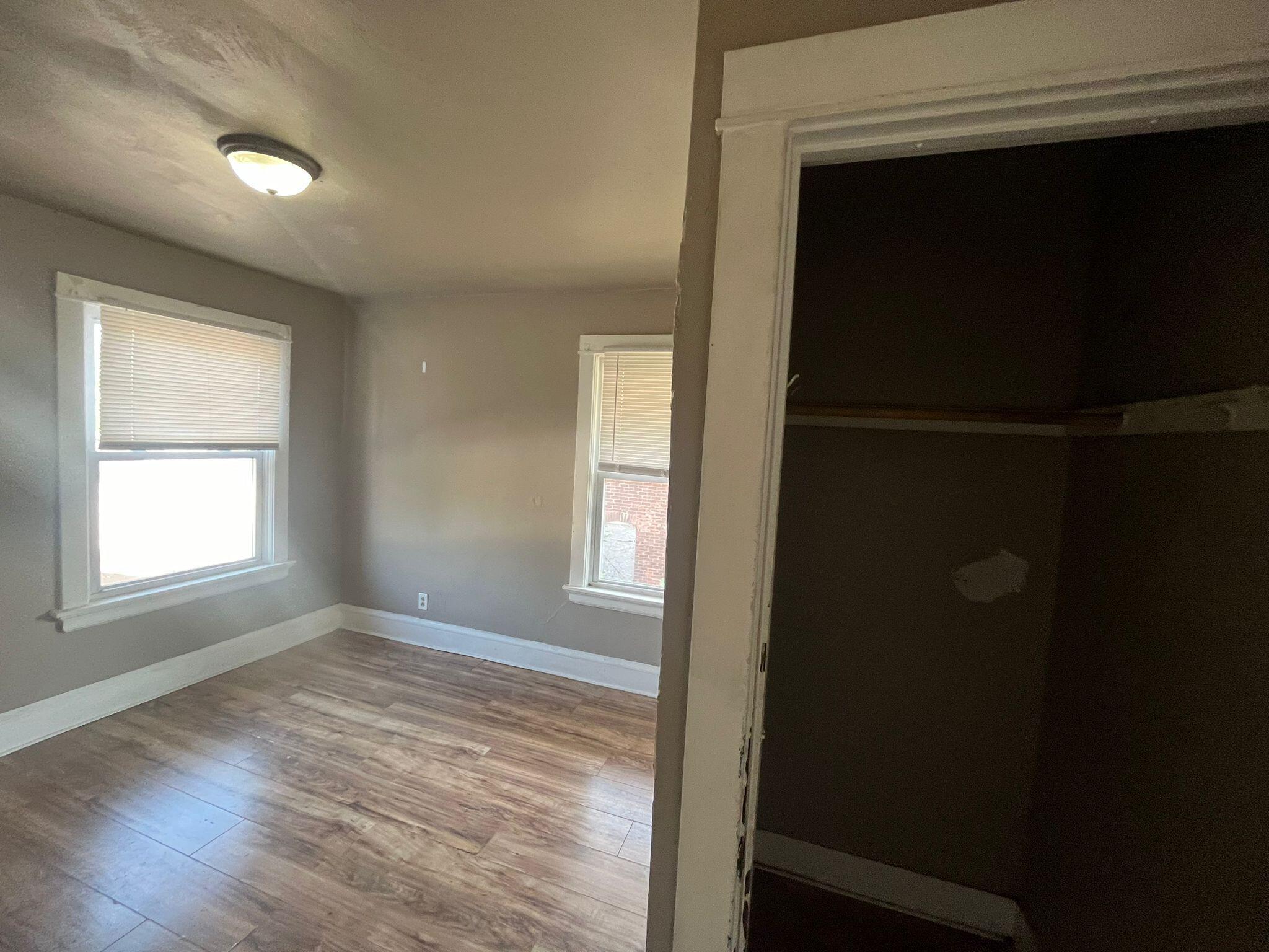 769 Buchanan Street Gary, IN 46402 - Photo 19 of 28 an empty room with wooden floor and windows