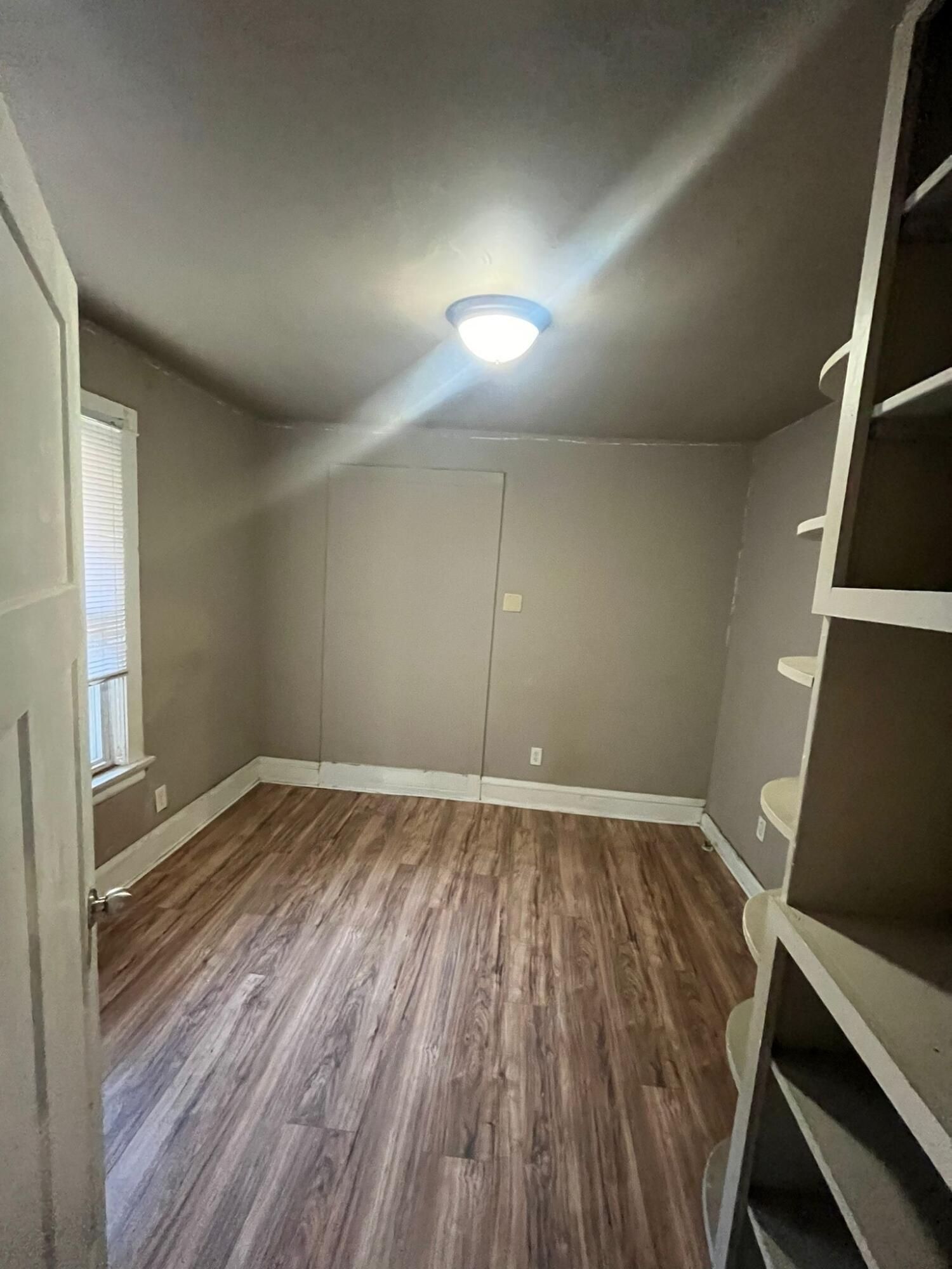 769 Buchanan Street Gary, IN 46402 - Photo 22 of 28 an empty room with wooden floor and windows
