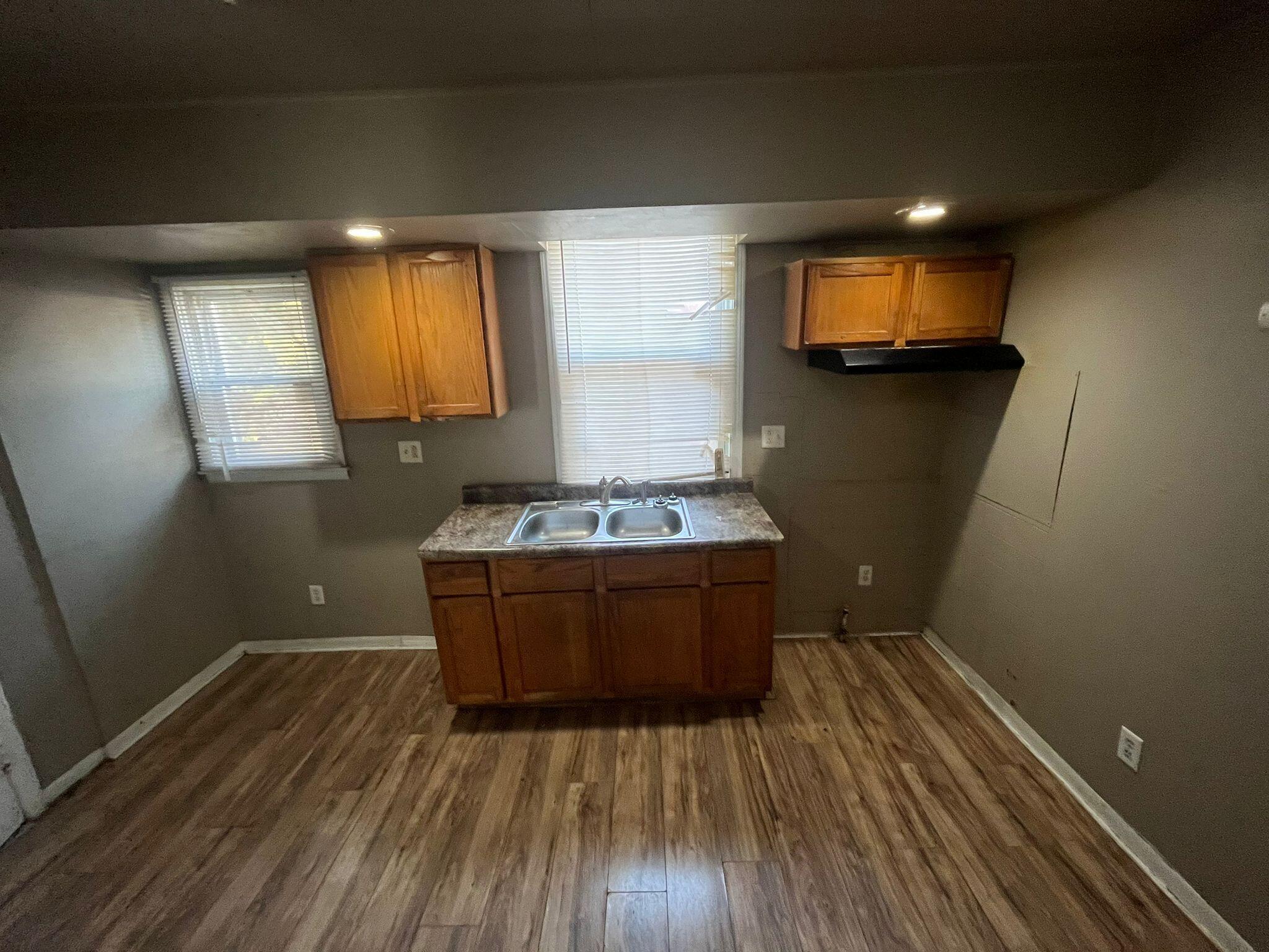 769 Buchanan Street Gary, IN 46402 - Photo 6 of 28 a room with wooden floor and furniture
