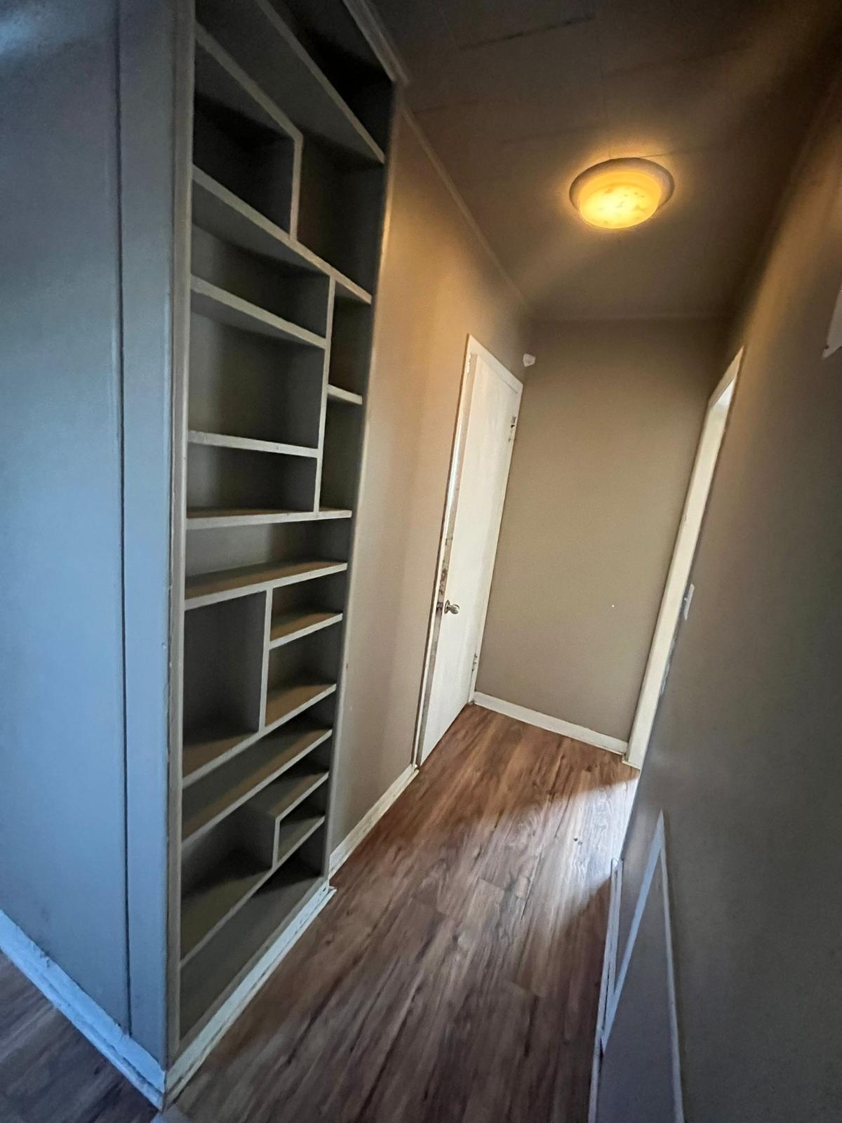769 Buchanan Street Gary, IN 46402 - Photo 9 of 28 a view of an empty room with a window and wooden floor