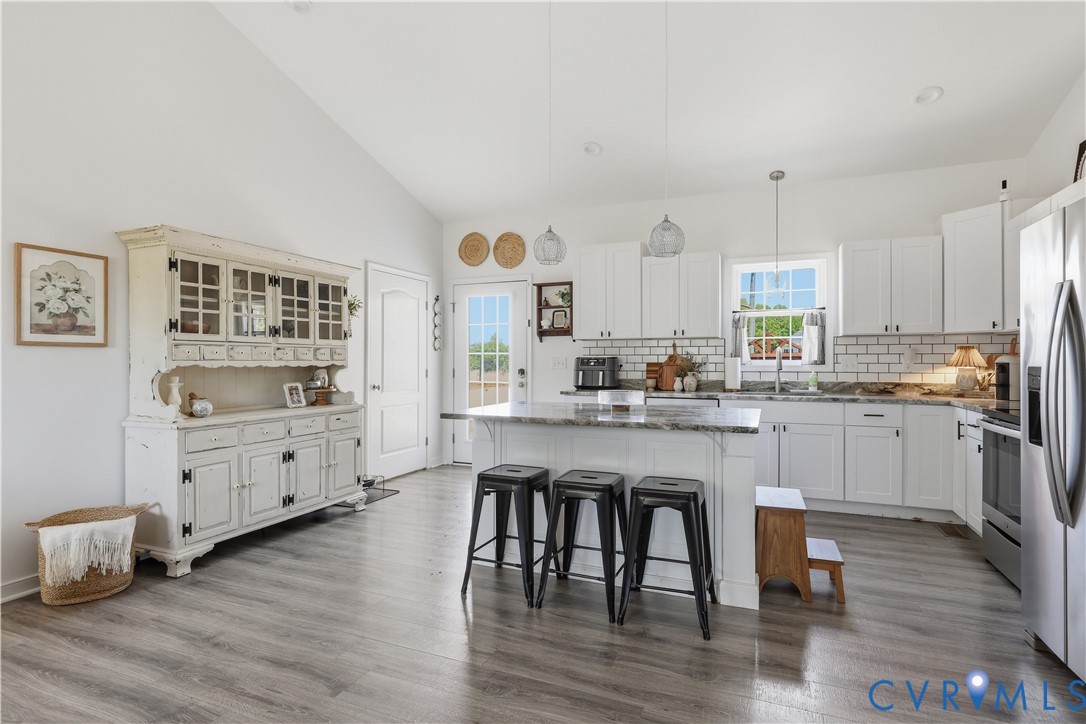 235 Stoney Point Road Cumberland, VA 23040 - Photo 15 of 35 a kitchen with white cabinets and wooden floor