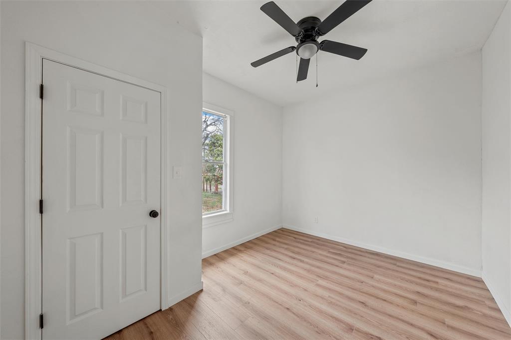 1504 Proctor Avenue Waco, TX 76708 - Photo 12 of 25 wooden floor in an empty room with a window