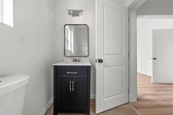 a bathroom with a toilet a sink and mirror