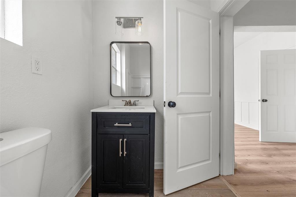 1504 Proctor Avenue Waco, TX 76708 - Photo 14 of 25 a bathroom with a toilet a sink and mirror