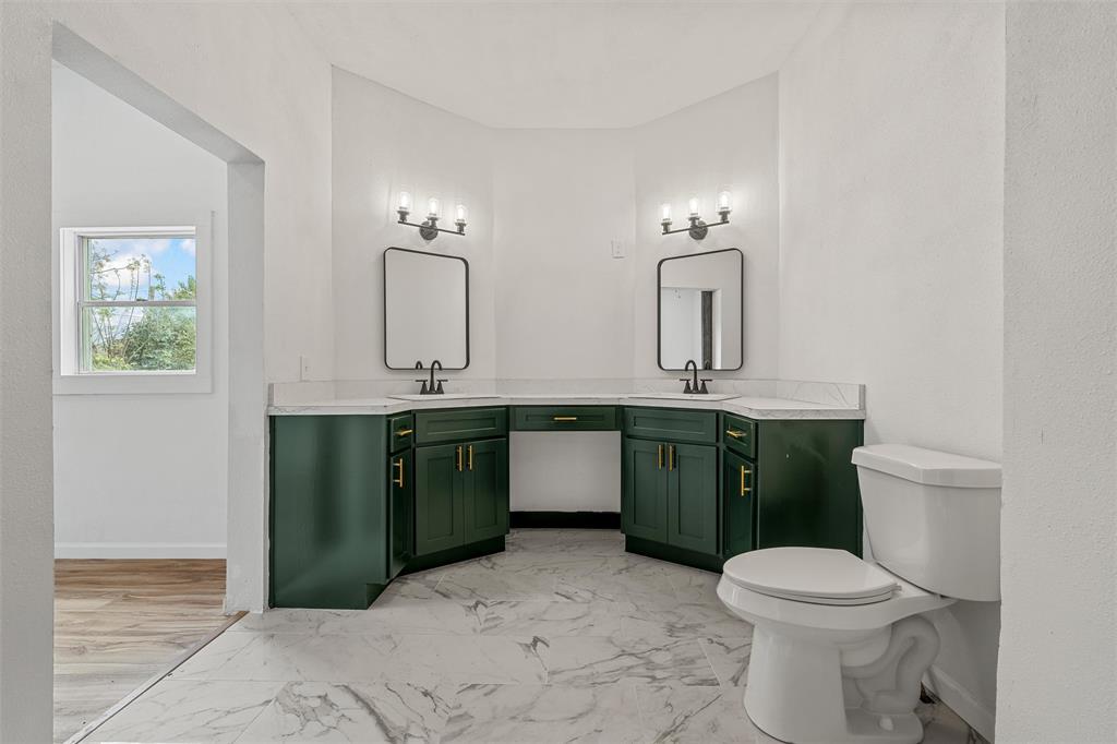 1504 Proctor Avenue Waco, TX 76708 - Photo 19 of 25 a bathroom with a toilet sink and mirror