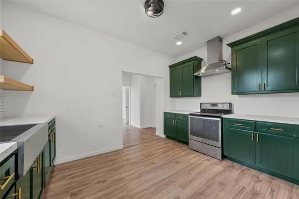 a kitchen with granite countertop a sink cabinets and wooden floor
