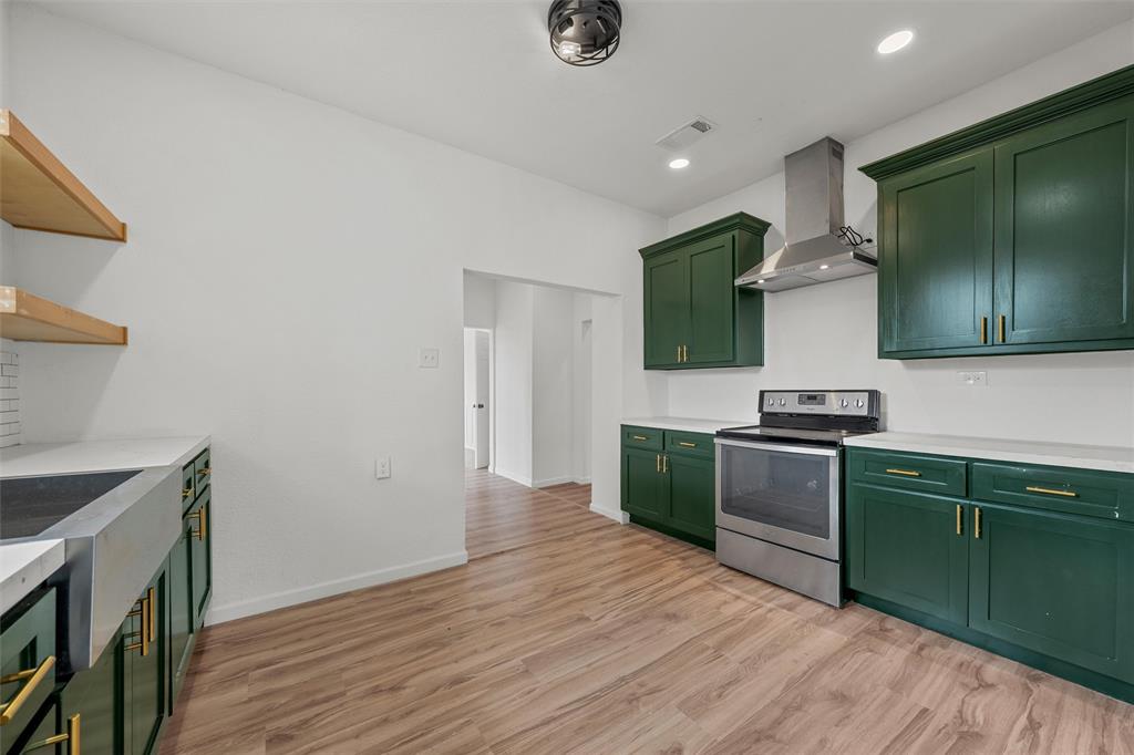 1504 Proctor Avenue Waco, TX 76708 - Photo 8 of 25 a kitchen with granite countertop a sink cabinets and wooden floor