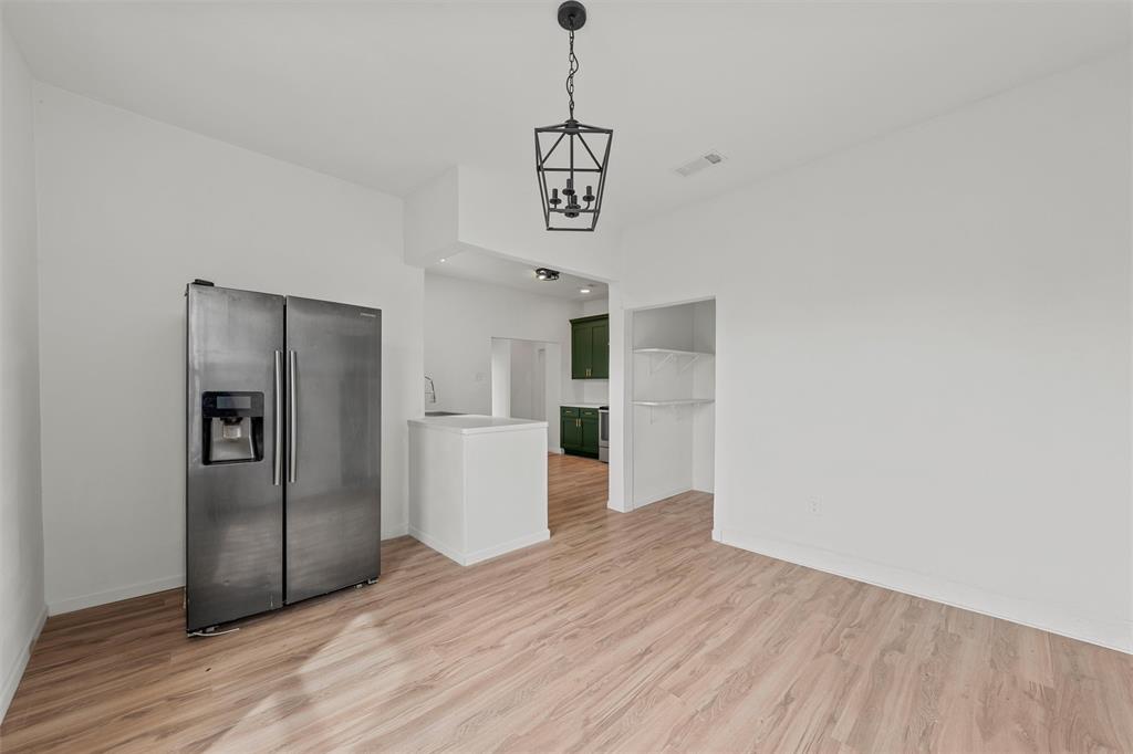 1504 Proctor Avenue Waco, TX 76708 - Photo 9 of 25 a view of a kitchen with wooden floor and a refrigerator