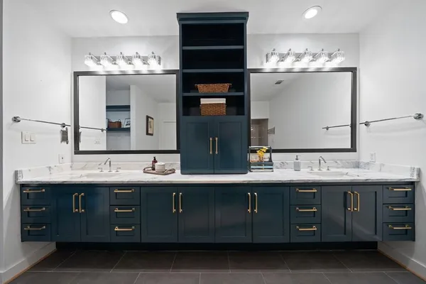 a bathroom with a sink double vanity and a mirror
