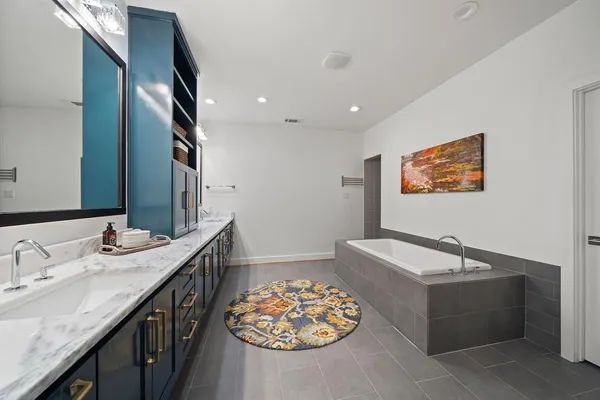 a bathroom with a tub sink and vanity