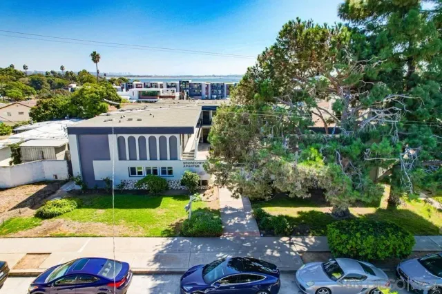 a view of a patio with plants and chairs