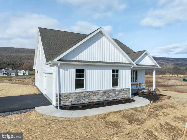 a front view of a house with a yard outdoor seating and garage