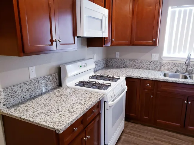 a kitchen with a sink stove and cabinets