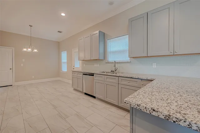 a kitchen with granite countertop a sink stainless steel appliances and cabinets