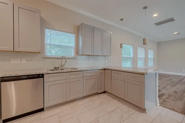 a kitchen with sink and cabinets