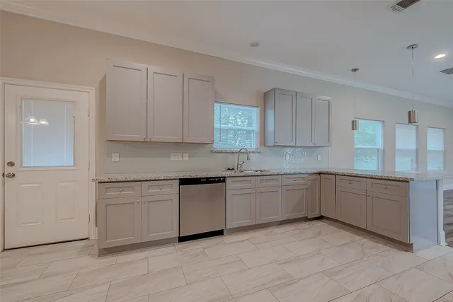 a kitchen with granite countertop white cabinets and white appliances