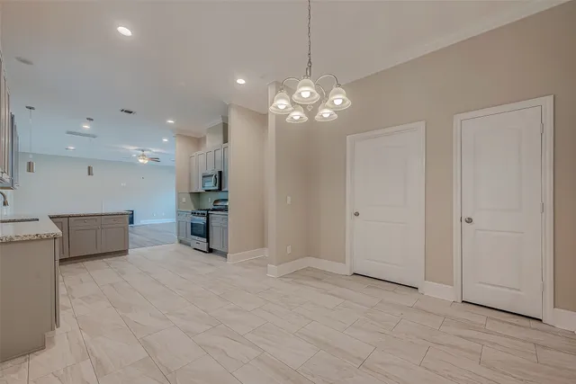 a view of a kitchen with a refrigerator a ceiling fan and wooden floor