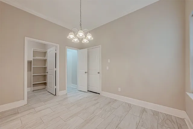 en empty room with wooden floor and ceiling fan