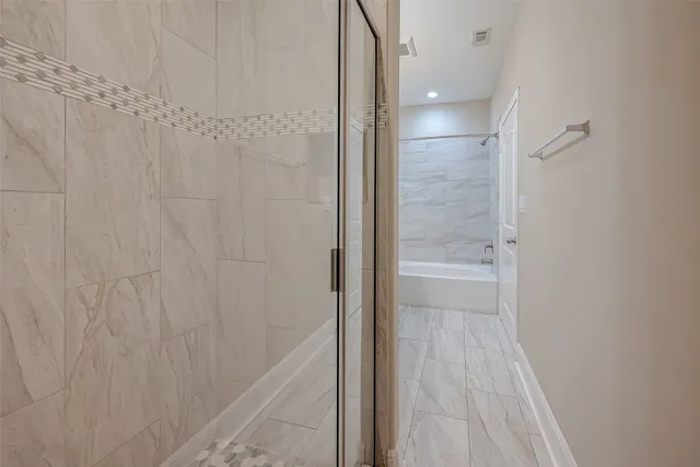 a bathroom with a shower and a sink