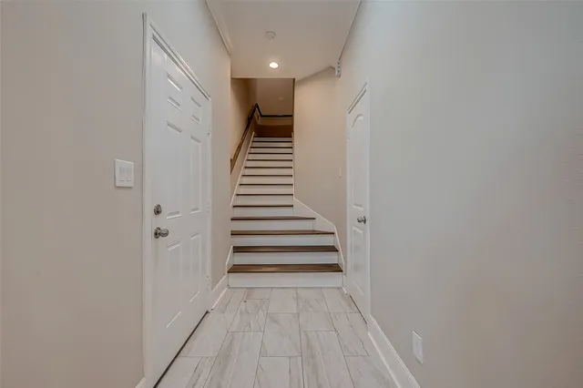 a view of a hallway with wooden floor and entryway