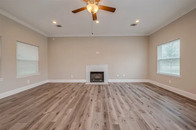 wooden floor chandelier and window in a room