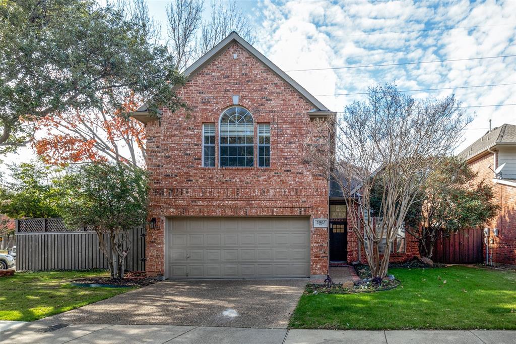 Front of property with a garage and a front lawn