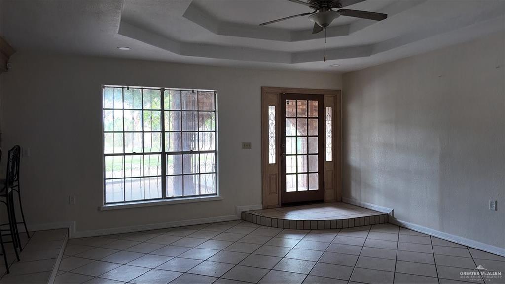 612 West Ramirez Street Rio Grande City, TX 78582 - Photo 13 of 40 Doorway with a ceiling fan, tile patterned flooring, and a raised ceiling