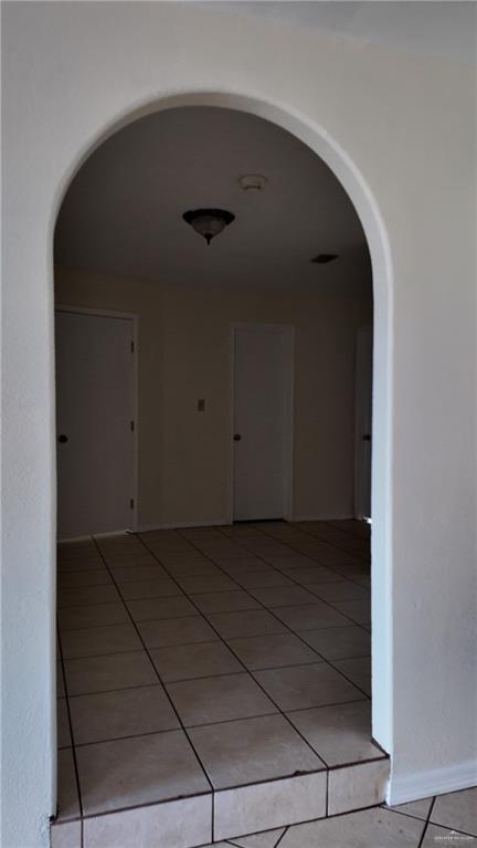 612 West Ramirez Street Rio Grande City, TX 78582 - Photo 27 of 40 Corridor with tile patterned flooring and arched walkways