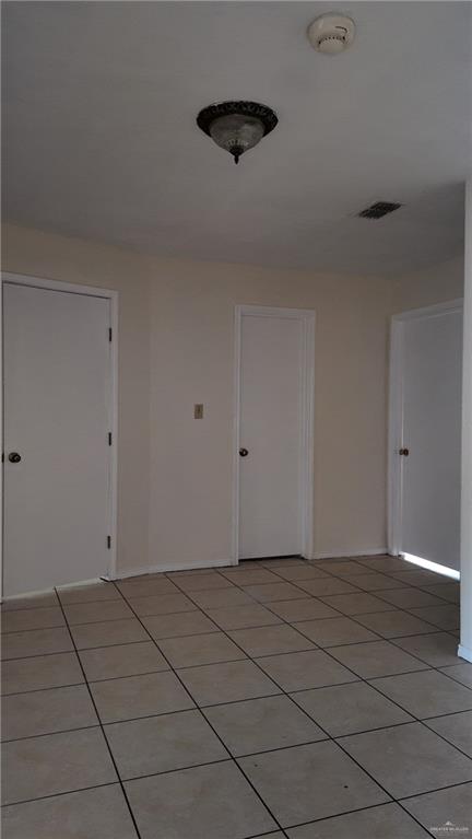 612 West Ramirez Street Rio Grande City, TX 78582 - Photo 28 of 40 Unfurnished room with a smoke detector and light tile patterned floors
