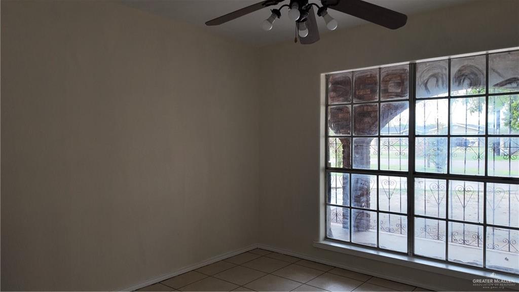 612 West Ramirez Street Rio Grande City, TX 78582 - Photo 29 of 40 Empty room with light tile patterned floors and a ceiling fan