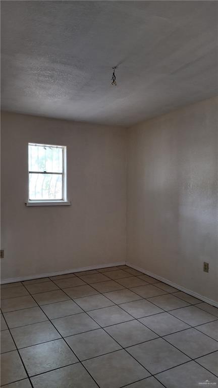 612 West Ramirez Street Rio Grande City, TX 78582 - Photo 31 of 40 Unfurnished room featuring light tile patterned flooring and baseboards