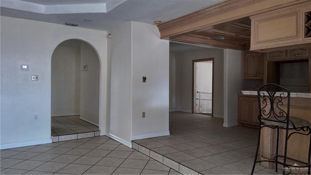 612 West Ramirez Street Rio Grande City, TX 78582 - Photo 37 of 40 Kitchen featuring light tile patterned floors, arched walkways, tile countertops, and beam ceiling