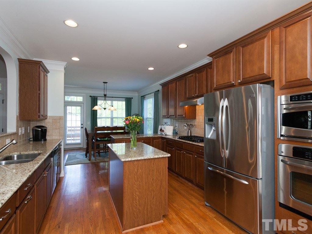 201 Challenge Road Raleigh, NC 27603 - Photo 2 of 25 a kitchen with stainless steel appliances granite countertop a refrigerator stove microwave and sink