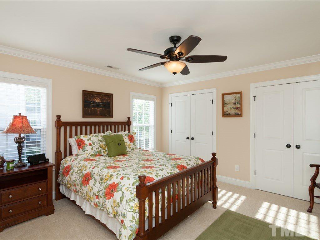 201 Challenge Road Raleigh, NC 27603 - Photo 14 of 25 a bedroom with a bed and a chandelier