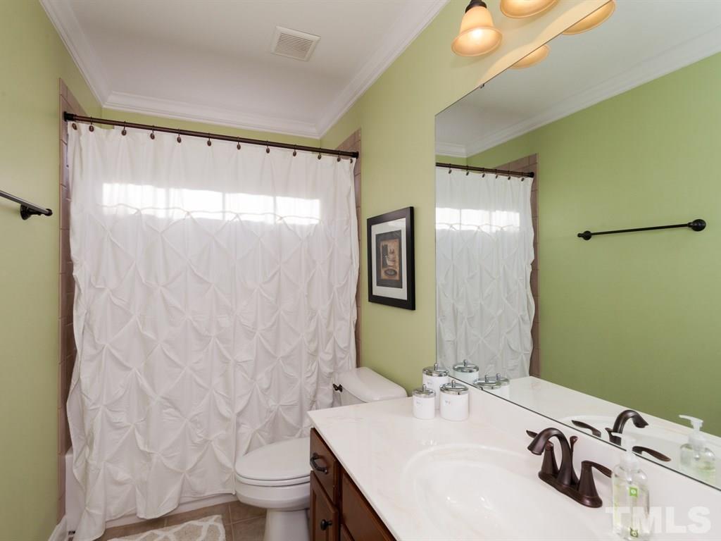 201 Challenge Road Raleigh, NC 27603 - Photo 17 of 25 a bathroom with a sink and a mirror