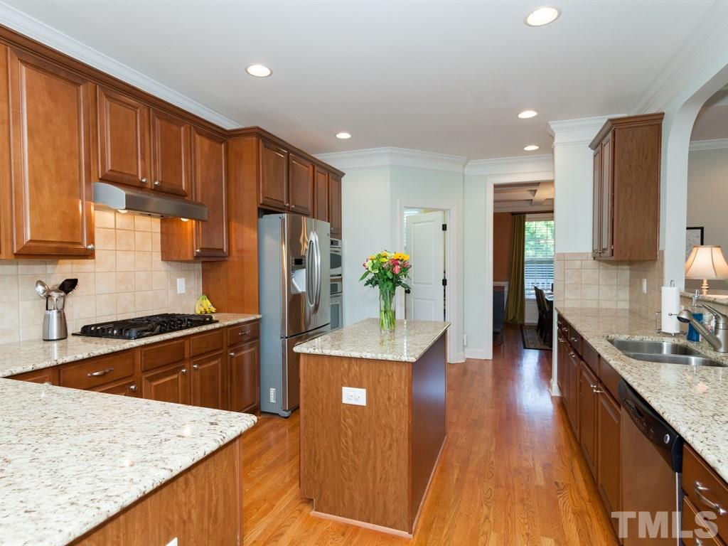 201 Challenge Road Raleigh, NC 27603 - Photo 3 of 25 a kitchen with stainless steel appliances granite countertop a refrigerator a sink dishwasher a stove with wooden cabinets and floor