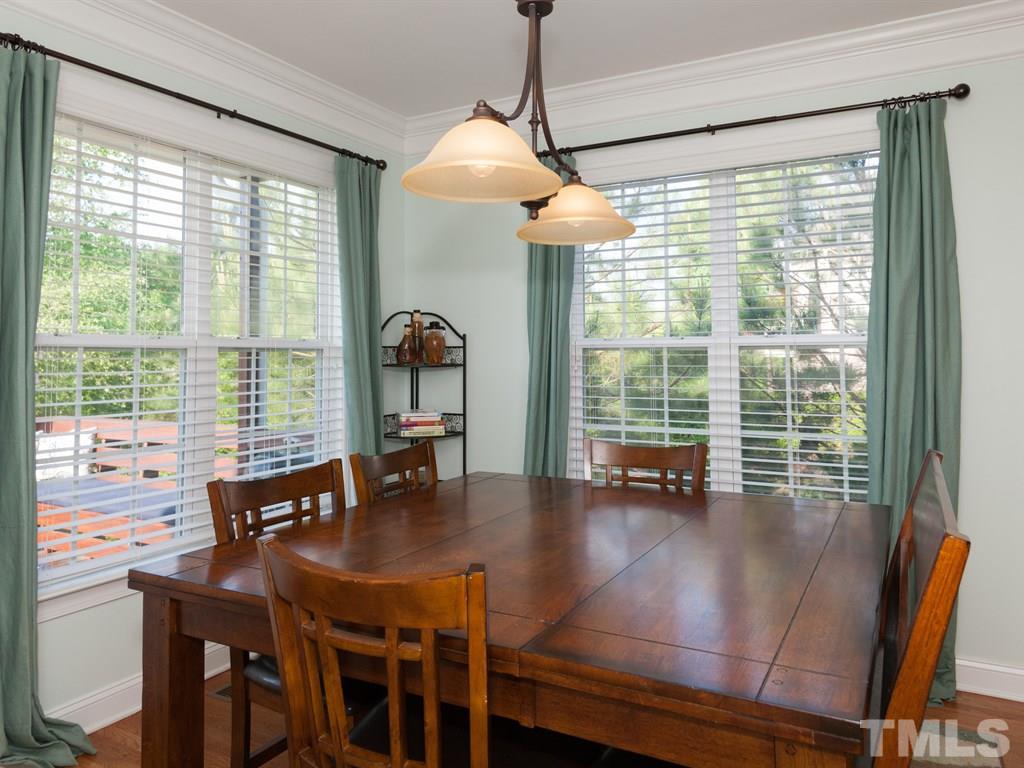 201 Challenge Road Raleigh, NC 27603 - Photo 5 of 25 a view of a dining room and livingroom with furniture wooden floor a chandelier