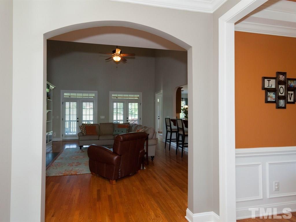 201 Challenge Road Raleigh, NC 27603 - Photo 8 of 25 a living room with furniture and a flat screen tv