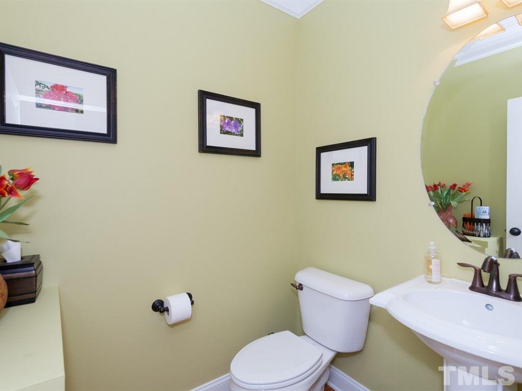 201 Challenge Road Raleigh, NC 27603 - Photo 10 of 25 a bathroom with a toilet sink and mirror