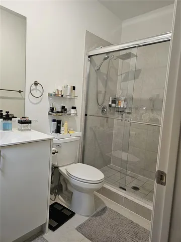 a bathroom with a shower a toilet and a sink