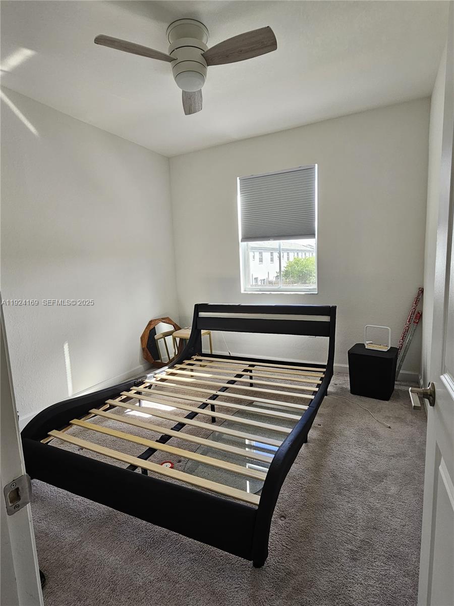 2637 Southeast 17th Street Homestead, FL 33035 - Photo 14 of 23 a bed sitting in a bedroom next to a window