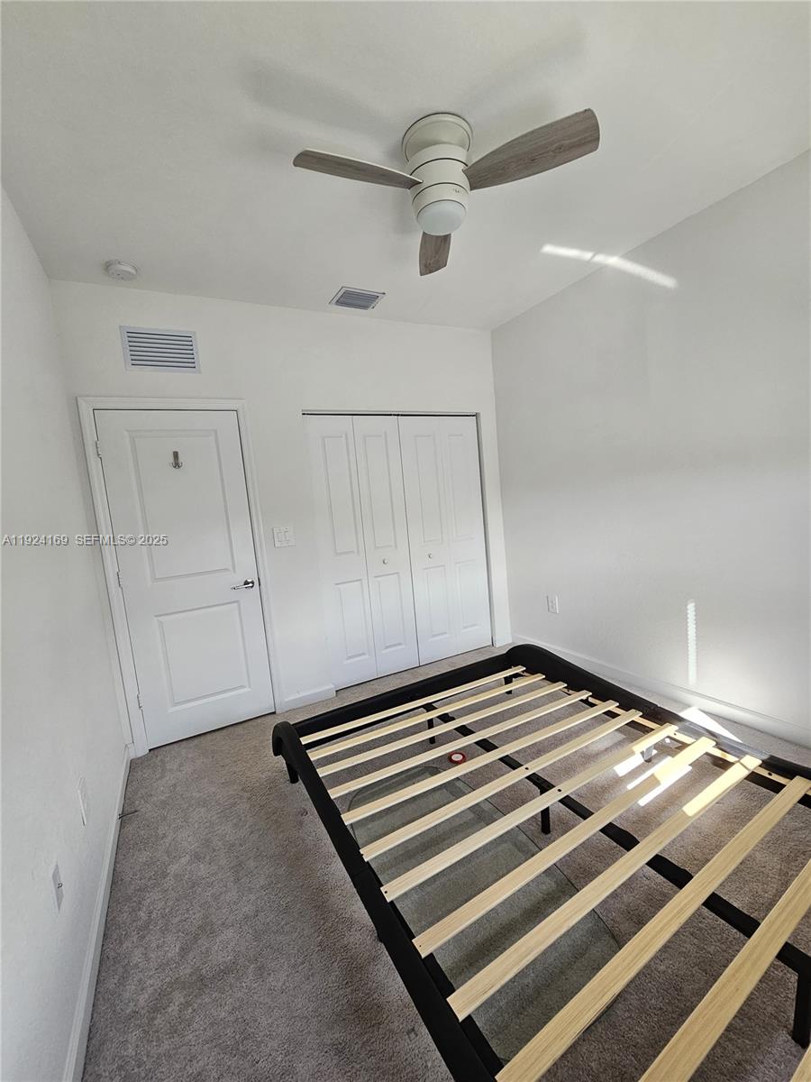 2637 Southeast 17th Street Homestead, FL 33035 - Photo 15 of 23 a bedroom with a bed and cabinets