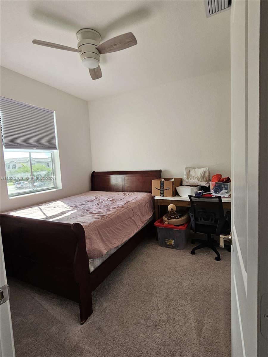 2637 Southeast 17th Street Homestead, FL 33035 - Photo 17 of 23 a bed sitting in a bedroom next to a window