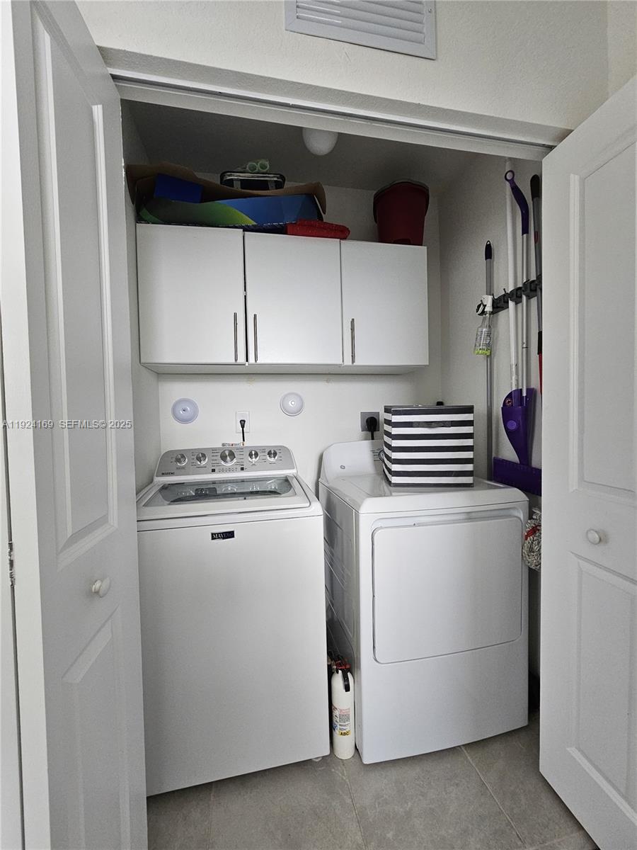 2637 Southeast 17th Street Homestead, FL 33035 - Photo 10 of 23 a view of washer and dryer with kitchen in the background