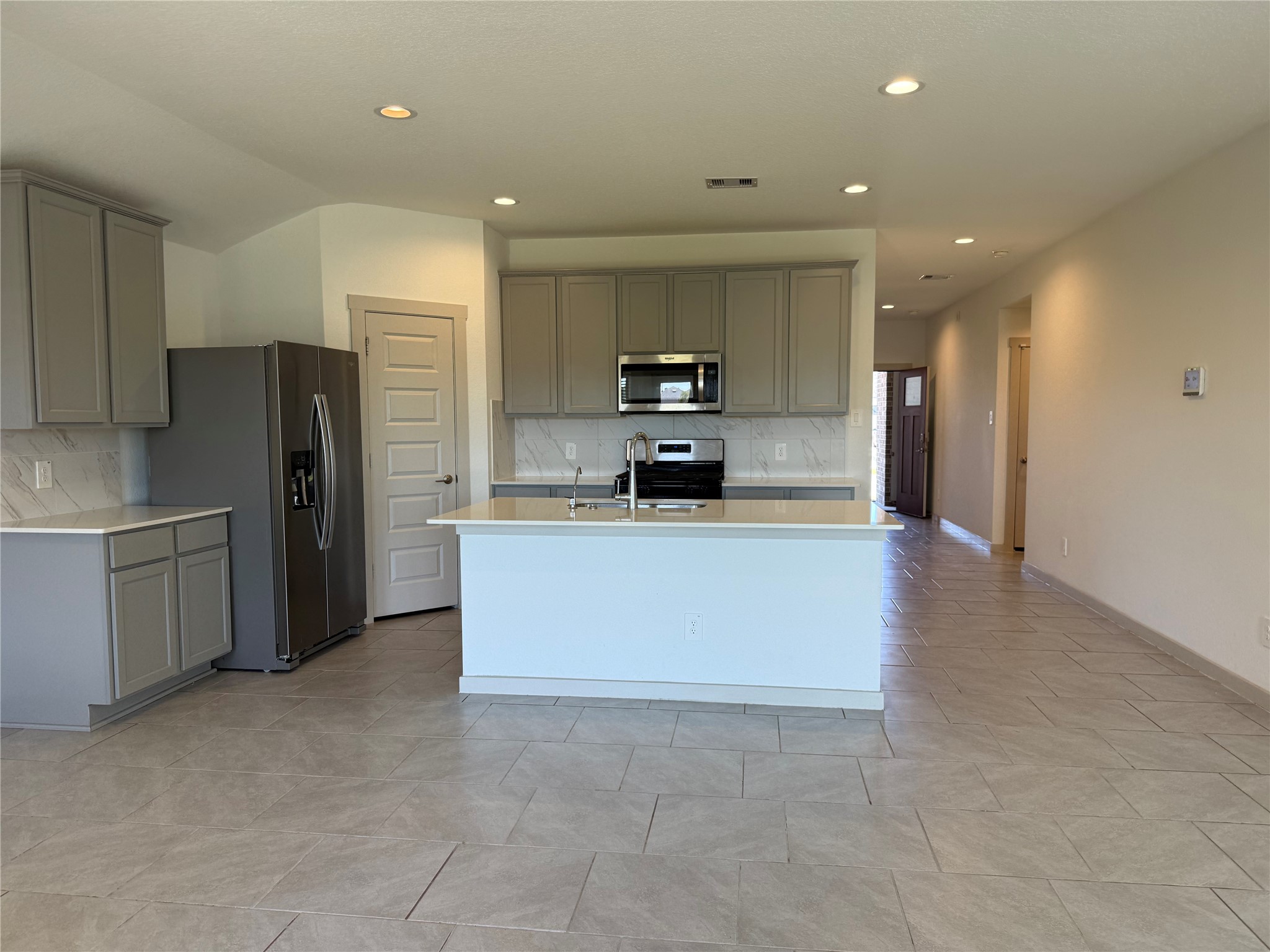 30007 Reagans Rnch Drive Katy, TX 77494 - Photo 11 of 23 a large kitchen with stainless steel appliances a refrigerator and a stove top oven