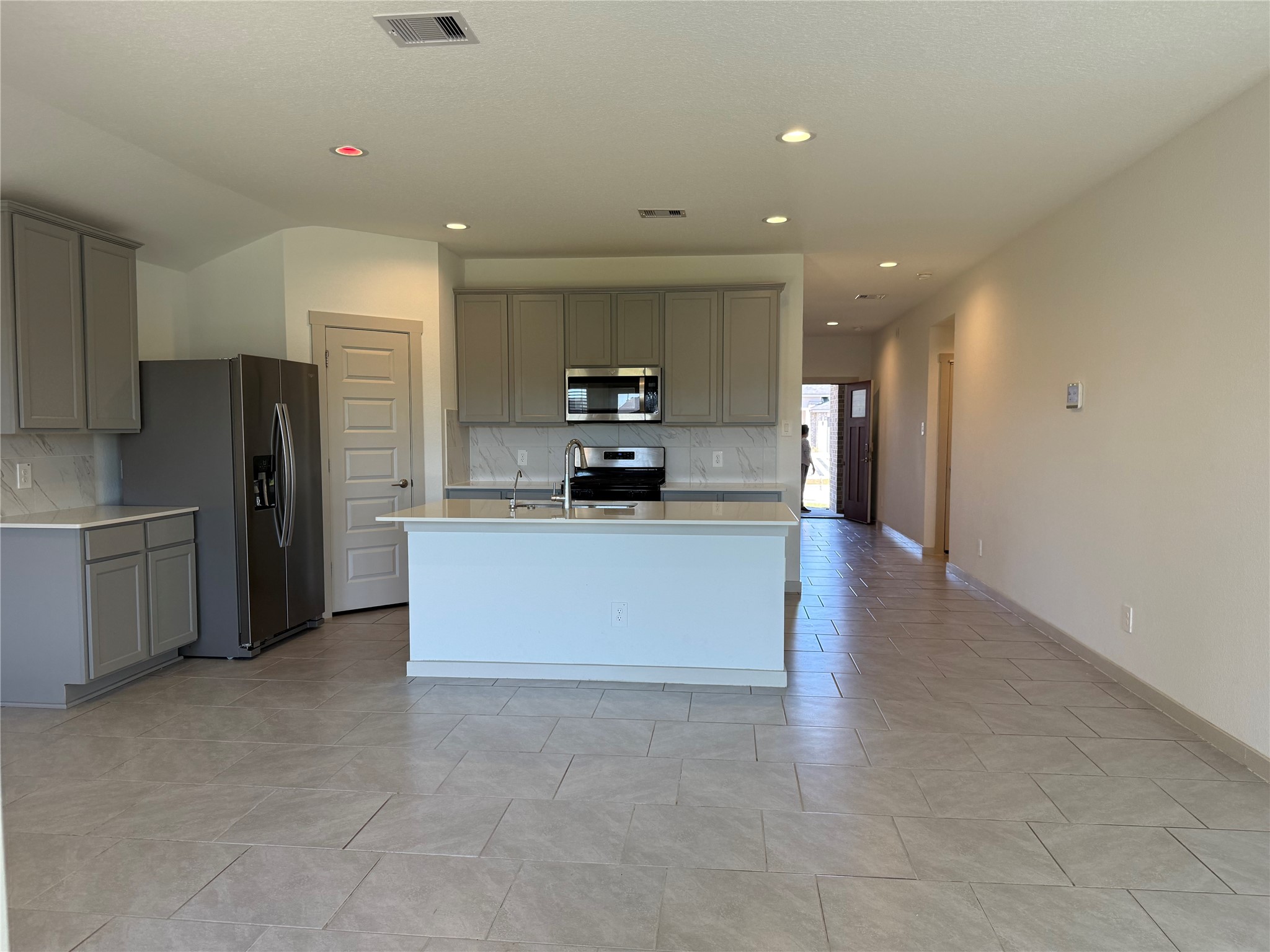 30007 Reagans Rnch Drive Katy, TX 77494 - Photo 12 of 23 a large kitchen with stainless steel appliances a refrigerator and a stove top oven