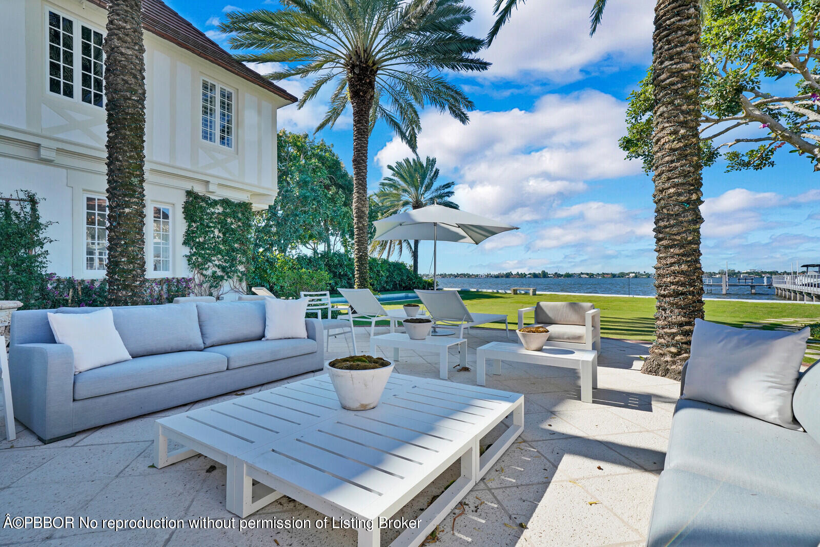 210 Via Del Mar Palm Beach, FL 33480 - Photo 79 of 85 a view of a patio with couches and a table and chairs with wooden fence