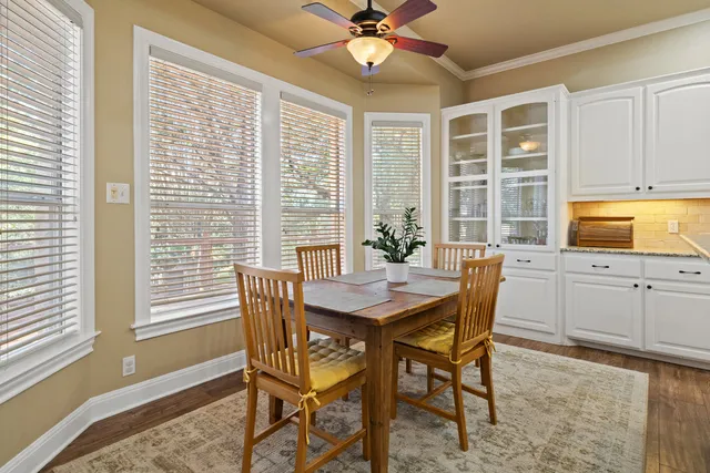 a kitchen with granite countertop white cabinets and white appliances