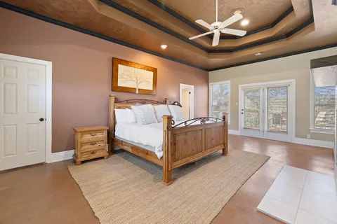 a spacious bedroom with a bed and large windows