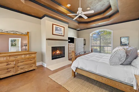 a bedroom with a bed and a fireplace